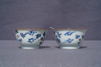 A pair of Chinese blue, white and underglaze red cups and saucers, Kangxi