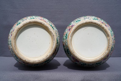 A pair of Chinese famille rose lady-handle vases, 19th C.