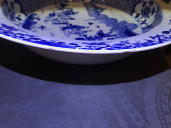 A deep Chinese blue and white dish with figures in a garden, Yongzheng