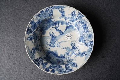 A Chinese blue and white deep plate with fighting warriors on horseback, Kangxi mark and of the period