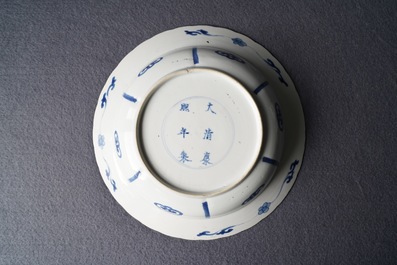 A Chinese blue and white deep plate with fighting warriors on horseback, Kangxi mark and of the period
