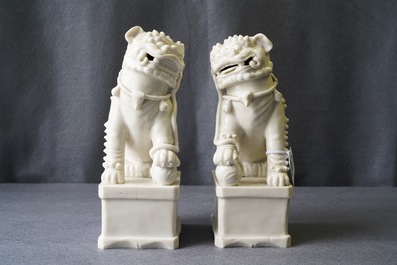 A pair of large Chinese Dehua blanc de Chine models of buddhist lions, Kangxi