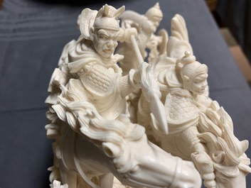A Chinese carved ivory group with warriors on horseback, 2nd quarter 20th C.