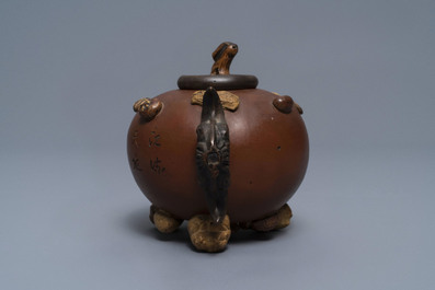 A Chinese Yixing stoneware relief-decorated teapot with nuts and fruits, Shao Er Quan mark, Daoguang