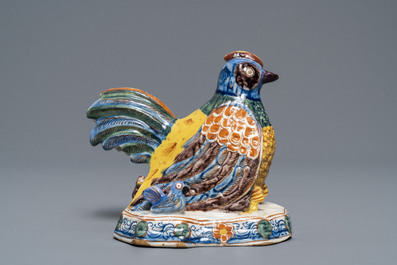 A polychrome Dutch Delft group of a hen with chickens, 18th C.