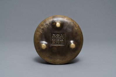 A flat Chinese bronze tripod censer, Xuande mark, 18th C.