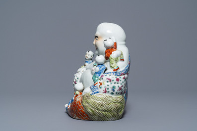 A Chinese famille rose figure of Buddha and a famille rose boy on qilin, 19th C.