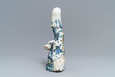 A rare Chinese wucai figure of Shoulao seated on a deer, Wanli