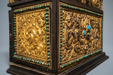 A turquoise-inlaid gilt bronze and copper repouss&eacute; 'tepchog' folding altar table, Tibet, 19th C.