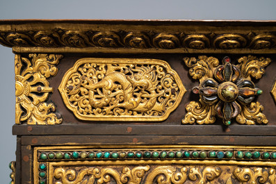 A turquoise-inlaid gilt bronze and copper repouss&eacute; 'tepchog' folding altar table, Tibet, 19th C.