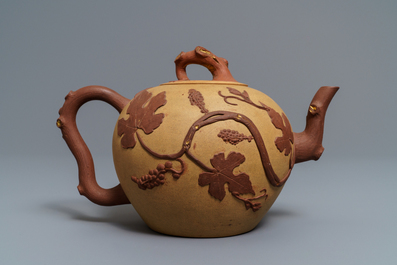 A large Chinese Yixing stoneware teapot with applied grape vines design, Kangxi