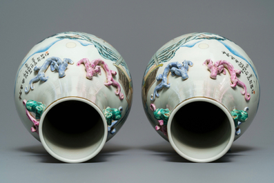 A pair of Chinese famille rose vases with figures in a landscape, 19/20th C.