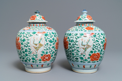 A pair of Chinese wucai vases and covers with boys among peonies, Transitional period