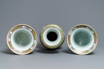 A pair of Chinese Canton famille rose spittoons and a vase, 19th C.