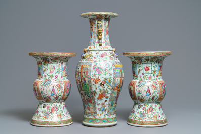 A pair of Chinese Canton famille rose spittoons and a vase, 19th C.