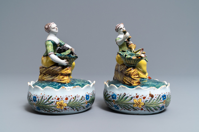 A pair of polychrome Dutch Delft butter tubs with ladies selling flowers and fruits, 18th C.