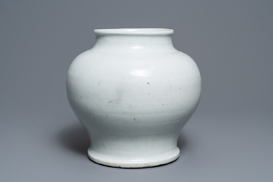 A Chinese monochrome white vase with a wooden cover and stand, Ming