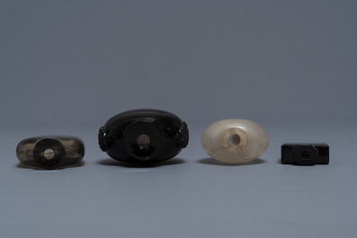 Four Chinese smokey quartz and simulating glass snuff bottles, 18/19th C.