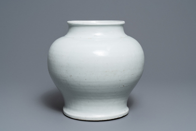 A Chinese monochrome white vase with a wooden cover and stand, Ming