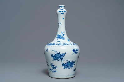 A Chinese blue and white bottle vase with floral design, Transitional period