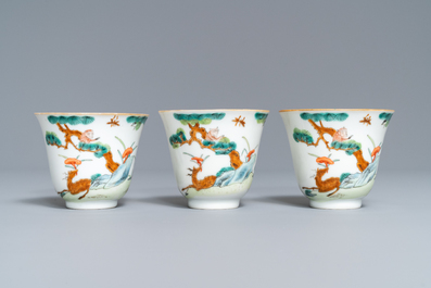 Three Chinese famille verte 'deer and monkey' cups and saucers, Tongzhi mark and of the period