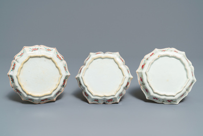 A Chinese famille rose relief-decorated teapot, milk jug and tea caddy on stands, Yongzheng