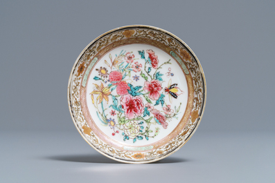 A fine Chinese famille rose cup and saucer with flowers and insects, Yongzheng