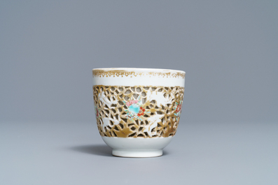 A reticulated Chinese famille rose cup and saucer, Qianlong
