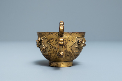 A Chinese relief-decorated gilt bronze cup, Ming