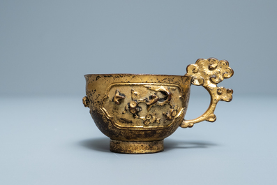 A Chinese relief-decorated gilt bronze cup, Ming