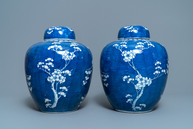 A pair of Chinese blue and white 'prunus on cracked ice' jars and covers, 19th C.