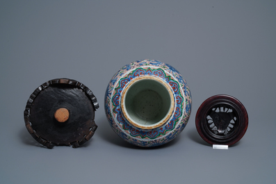 A Chinese wucai 'lotus scroll' jar with wooden cover and stand, Transitional period