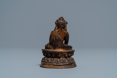 A Sino-Tibetan gilt bronze figure of Buddha, 16/17th C.