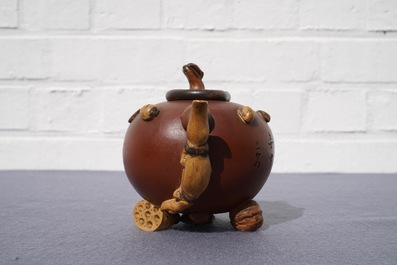 A Chinese Yixing stoneware relief-decorated teapot with nuts and fruits, Shao Er Quan mark, Daoguang