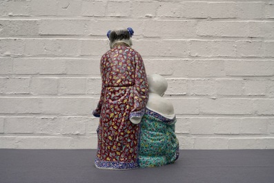 A Chinese famille rose group of two children, impressed marks, Republic, 20th C.