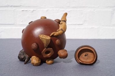 A Chinese Yixing stoneware relief-decorated teapot with nuts and fruits, Shao Er Quan mark, Daoguang