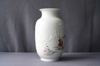 A Chinese famille rose relief-decorated vase with playing boys, Qianlong mark, Republic, 20th C.