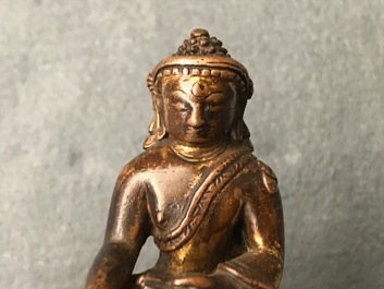 A Sino-Tibetan gilt bronze figure of Buddha, 16/17th C.