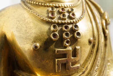 An inscribed Chinese gilt bronze figure of Buddha standing, Qianlong