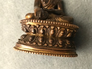 A Sino-Tibetan gilt bronze figure of Buddha, 16/17th C.