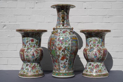 A pair of Chinese Canton famille rose spittoons and a vase, 19th C.