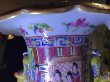 A pair of Chinese Canton famille rose spittoons and a vase, 19th C.