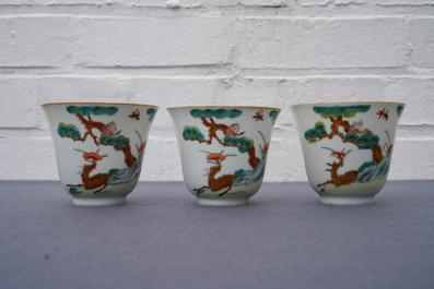 Three Chinese famille verte 'deer and monkey' cups and saucers, Tongzhi mark and of the period