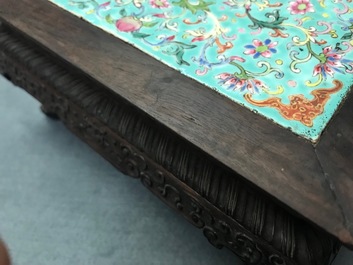 A Chinese carved wooden stand with famille rose plaque, 19th C.