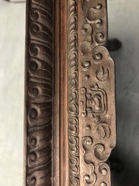 A Chinese carved wooden stand with famille rose plaque, 19th C.