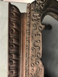 A Chinese carved wooden stand with famille rose plaque, 19th C.