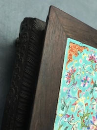 A Chinese carved wooden stand with famille rose plaque, 19th C.