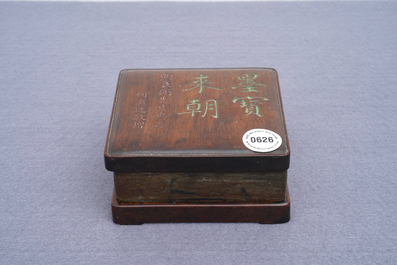 A square Chinese inscribed wood-encased duan inkstone, 19/20th C.