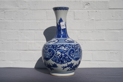 A Chinese blue and white bottle vase with dancers on a floral ground, 19th C.