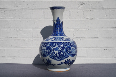 A Chinese blue and white bottle vase with dancers on a floral ground, 19th C.